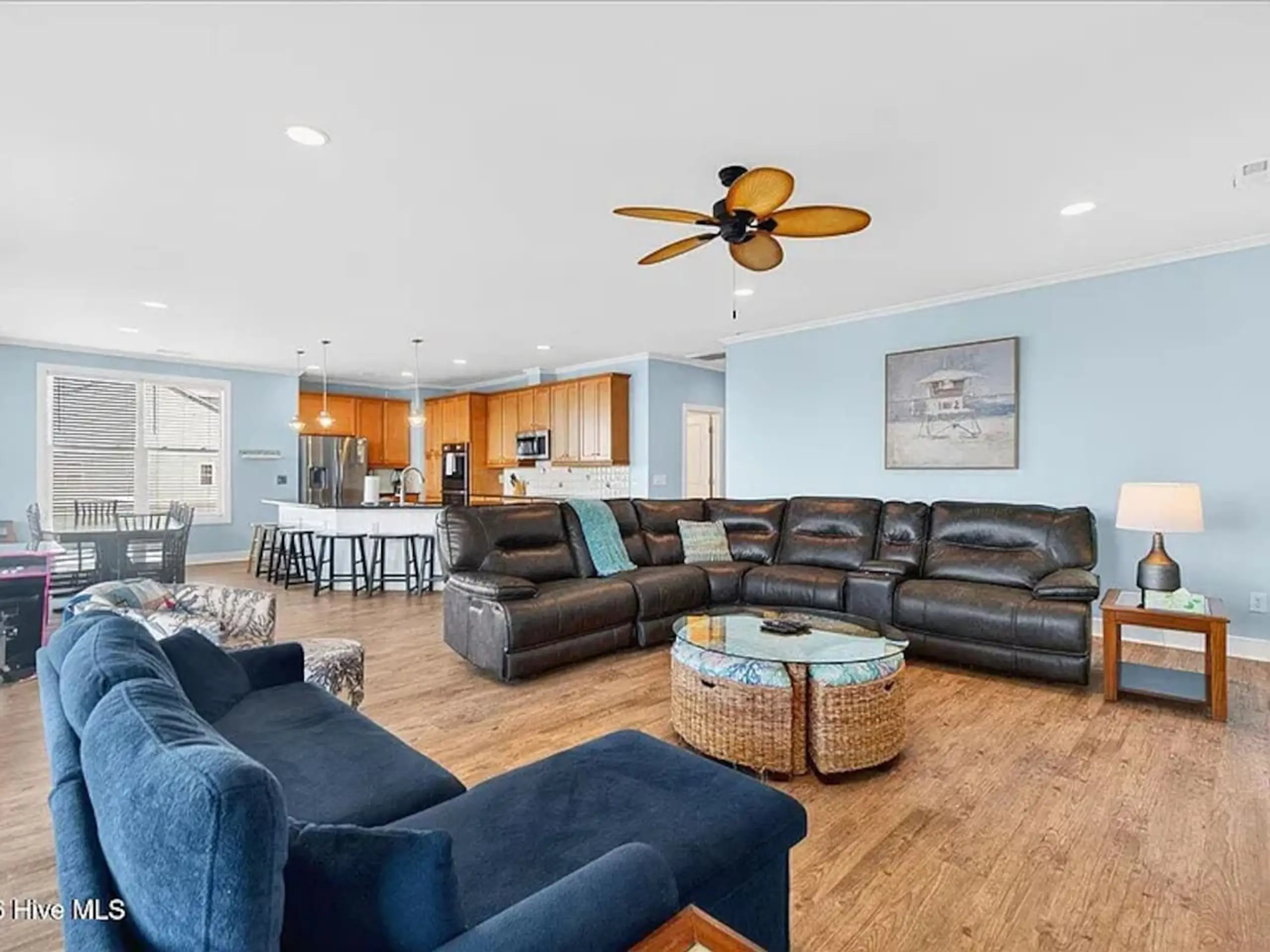 Spacious open plan living room with leather sectional