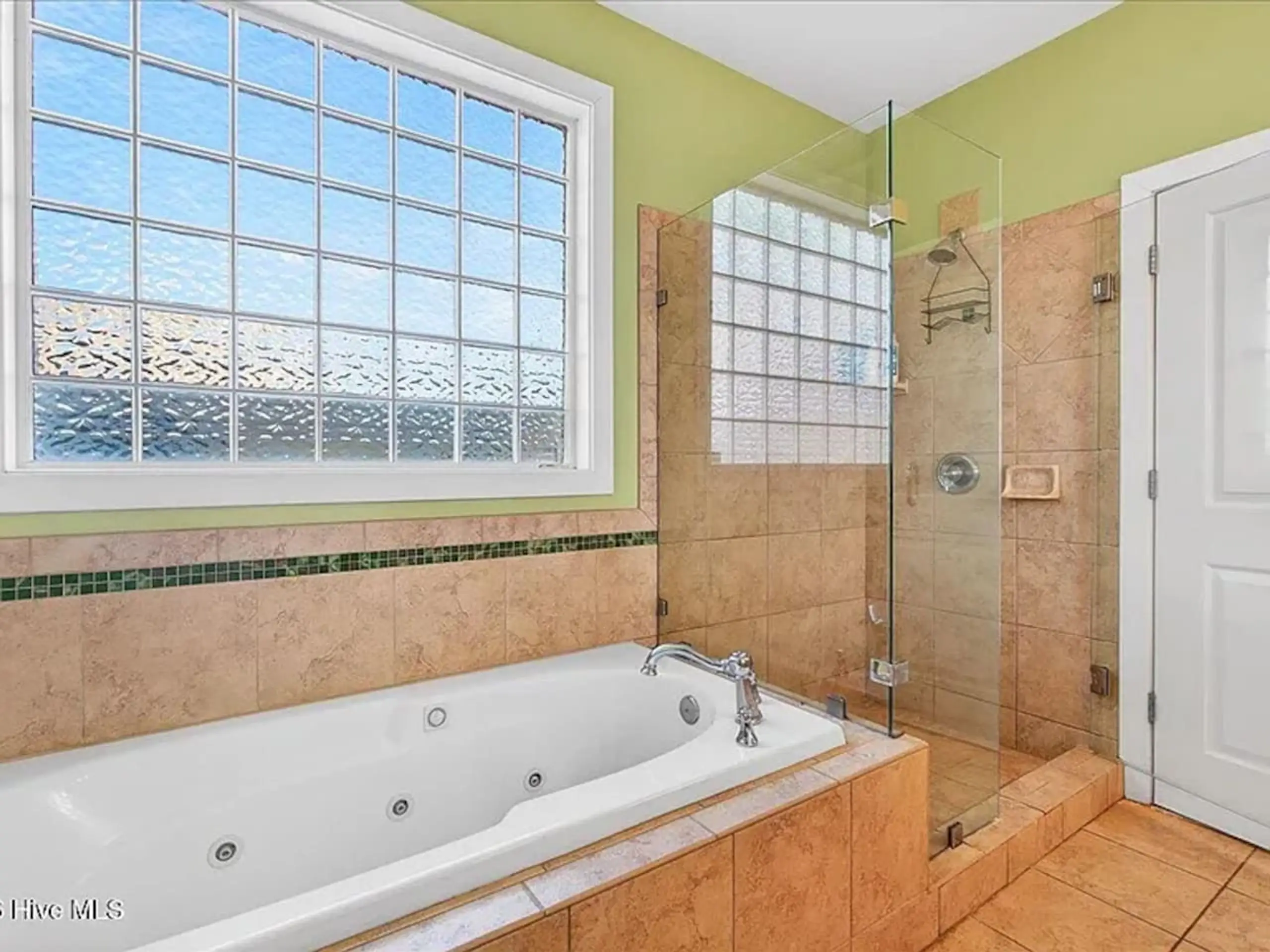 Modern bathroom with jetted tub and glass shower